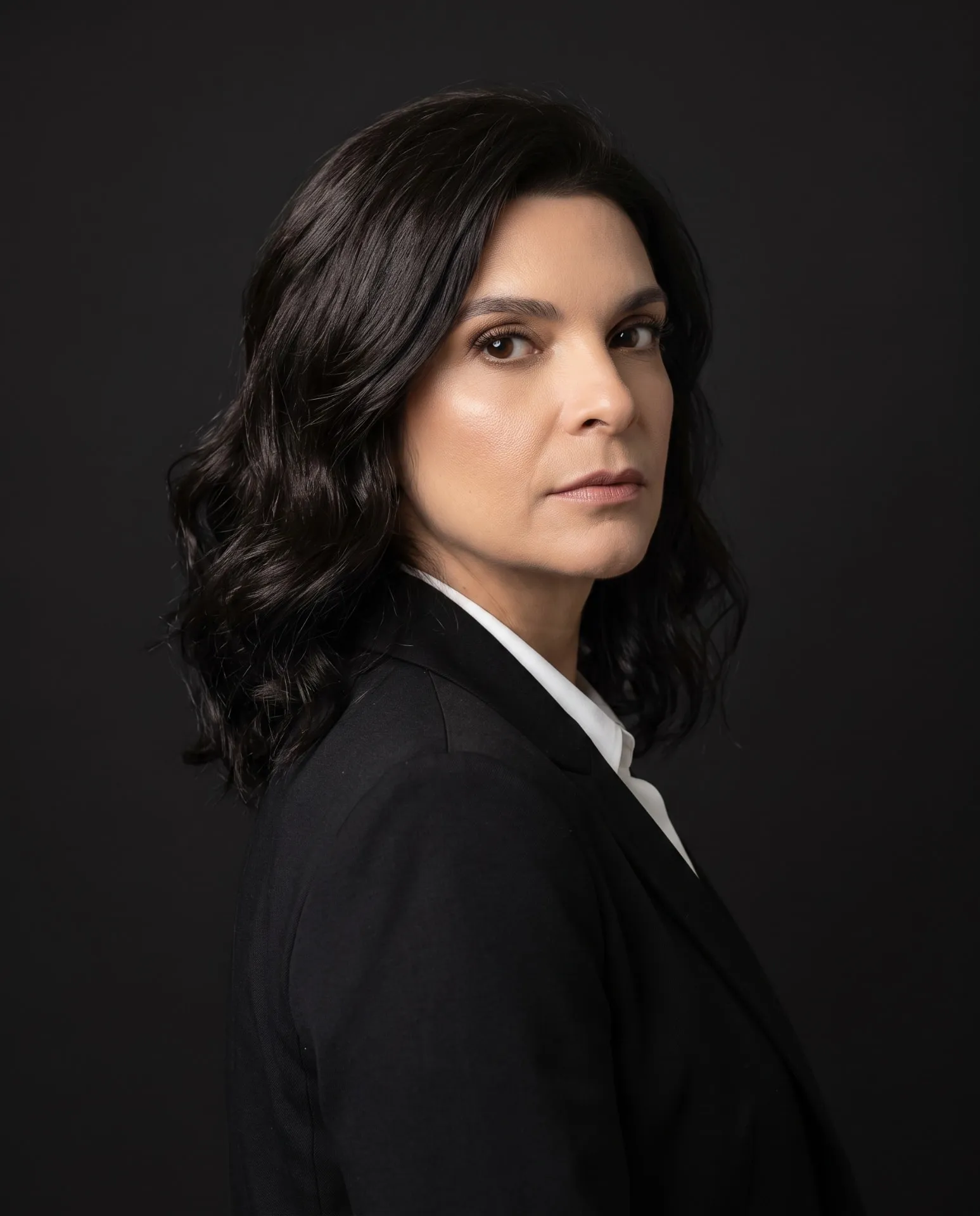 Studio portrait of Emilie Valencia against a dark background